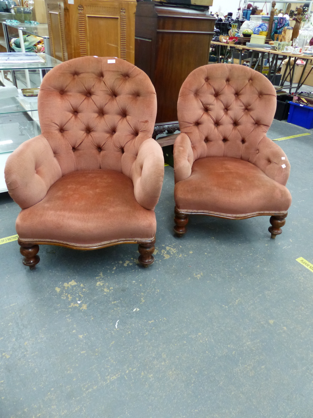 A NEAR PAIR OF VICTORIAN BUTTON BACK ARMCHAIRS