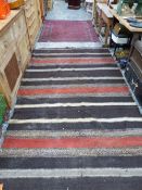 A LARGE FLATWEAVE CARPET AND AN EASTERN RUG.