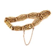 A ANTIQUE 15ct YELLOW GOLD FANCY GATE BRACELET WITH ATTACHED SAFETY CHAIN AND BOX CLASP. STAMPED 15,