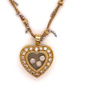 AN PRECIOUS YELLOW METAL AND DIAMOND FLOATING HEART PENDANT, ASSESSES AS 18CT FINENESS, SUSPENDED ON