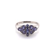 A 9ct WHITE GOLD HALLMARKED TANZANITE AND DIAMOND CLUSTER DRESS RING. FINGER SIZE S. WEIGHT 3.1grms.