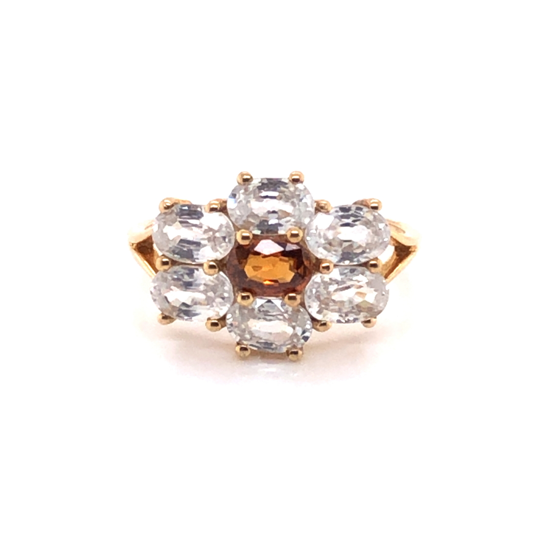 A MODERN 9ct GOLD DRESS RING, THE SEVEN GEMSTONES IN A HORIZONTAL CLAW SETTING. FINGER SIZE S.