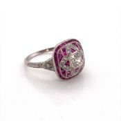AN ANTIQUE STYLE PLATINUM, RUBY AND DIAMOND COCKTAIL RING. THE CENTRAL DIAMOND AN OLD CUT, WITH