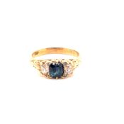 AN ANTIQUE 18ct GOLD STAMPED SAPPHIRE AND DIAMOND THREE STONE CARVED RING WITH A FURTHER FOUR ROSE