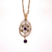 A VINTAGE PRECIOUS YELLOW METAL ASSESSED AS 375 FINENESS AMETHYST AND PEARL OPEN WORK PENDANT