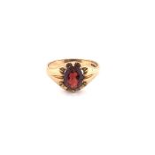 A VINTAGE 1950'S GENTS GARNET SIGNET RING. THE OVAL GARNET IN A CLAW SETTING. HALLMARKED LONDON