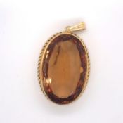 A LARGE PASTE SINGLE STONE PENDANT. SET WITH AN OVAL SHAPED MIXED CUT ORANGE PASTE, MEASURING APPROX