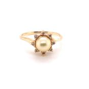 A 14K STAMPED YELLOW PRECIOUS METAL CULTURED PEARL AND DIAMOND RING. THE PRINCIPLE GOLDEN PEARL