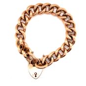 AN ANTIQUE 9ct STAMPED ROSE GOLD CHARM BRACELET WITH ATTACHED SAFETY CHAIN AND PADLOCK CLASP. LENGTH