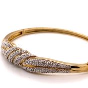 A 9ct HALLMARKED GOLD AND DIAMOND BANGLE. THE HINGED BANGLE COMPLETE WITH ATTACHED FIGURE OF EIGHT