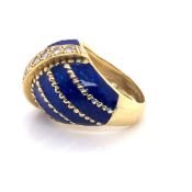 A PRECIOUS YELLOW METAL, DIAMOND AND BLUE ENAMEL BOMBAY RING. THE ROW OF TEN DIAMONDS IN A CHANNEL