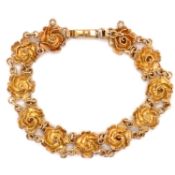 A VINTAGE 9ct YELLOW GOLD HALLMARKED STYLISED ROSE LINK BRACELET. DATED 1983. LENGTH 19cms. WEIGHT