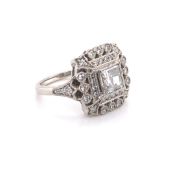 A PLATINUM AND DIAMOND ART DECO STYLE COCKTAIL RING. THE CENTRE DIAMOND A MIXED RADIANT CUT