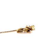 A REMODELLED ARTICULATED BEAR STICK PIN. THE BEAR ORIGINALLY A 9ct GOLD CHARM, MOST OF THE