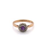 AN ANTIQUE 9ct STAMPED AMETHYST AND DIAMOND CLUSTER RING. FINGER SIZE O. WEIGHT 2grms.