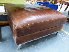 A LEATHER UPHOLSTERED OTTOMAN STOOL.