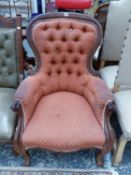 A VICTORIAN SHOW FRAME BUTTON BACK ARM CHAIR.