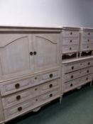 A CREAM PAINTED SUITE OF BEDSIDE CHESTS, A CHEST OF THREE DRAWERS AND A TELEVISION CABINET