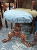 A WALNUT TRIPOD PIANO STOOL