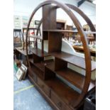 A TEAK SET OF SHELVE OPEN WITHIN ROUND ARCHED TOP ABOVE THREE DRAWERS