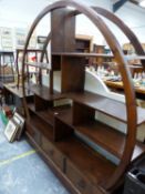 A TEAK SET OF SHELVE OPEN WITHIN ROUND ARCHED TOP ABOVE THREE DRAWERS