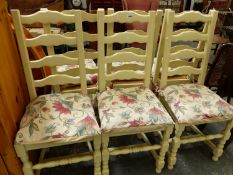 A SET OF SIX RUSH SEAT LADDER BACK PAINTED CHAIRS, AND A PINE TOPPED EXTENDING BREAKFAST TABLE.