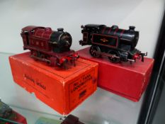 A HORNBY BOXED O GAUGE CLOCKWORK LMS 040 LOCOMOTIVE TOGETHER WITH A BLACK BRITISH RAIL 040