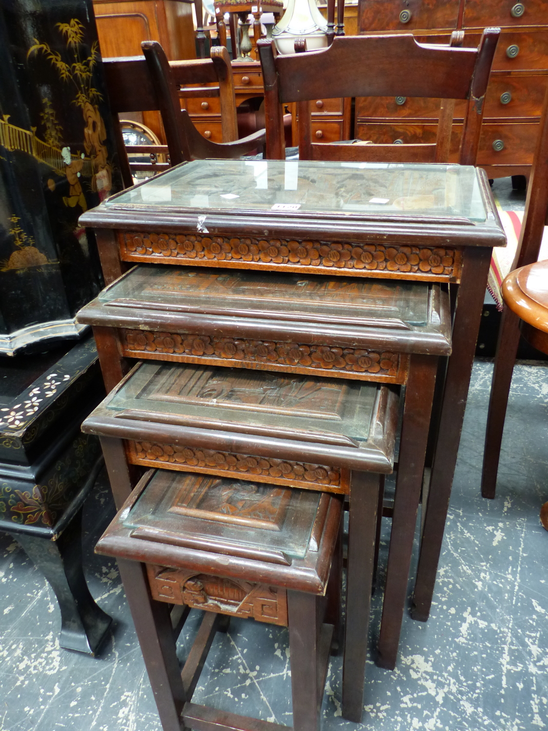 A NEST OF FOUR CHINESE CARVED WOOD TABLES