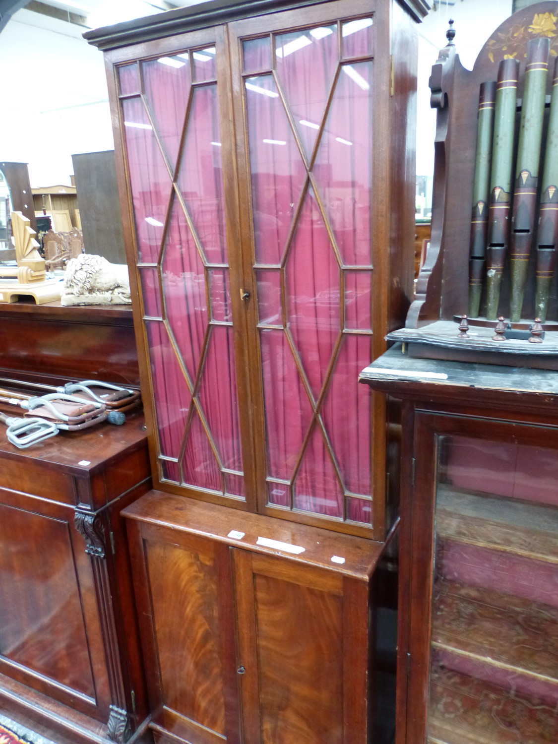 A MAHOGANY SIDE CABINET, THE TOP WITH ASTRAGAL GLAZED DOORS OVER SHELVES ABOVE PANELLED DOORS. W