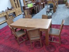 A HEALS OAK DINING TABLE AND SIX CHAIRS, THE LATTER WITH CANTED SQUARE BACKS, DROP IN SEATS AND