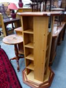 AN OAK REVOLVING TALL BOOKCASE AND A HARDWOOD TRIPOD OCCASIONAL TABLE.
