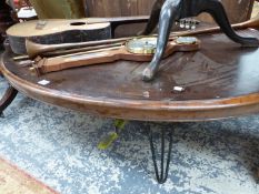 A MAHOGANY OVAL COFFEE TABLE ON IRON LEGS