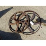 TWO SIMILAR CAST IRON CART WHEELS.