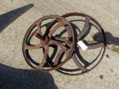 TWO SIMILAR CAST IRON CART WHEELS.