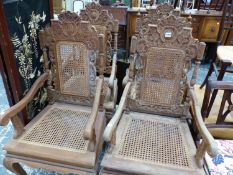 A SET OF FOUR CARVED OAK ELBOW CHAIRS WITH CANED BACKS AND SEATS