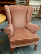 A SMALL WINGBACK ARM CHAIR.