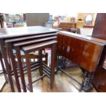 A MAHOGANY NEST OF FOUR TABLES TOGETHER WITH A MAHOGANY SUTHERLAND TABLE