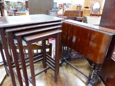 A MAHOGANY NEST OF FOUR TABLES TOGETHER WITH A MAHOGANY SUTHERLAND TABLE