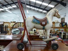 A VINTAGE TRI-ANG PUSH ALONG HORSE, AND A LATER PUSH ALONG PLUSH DOG TOY.