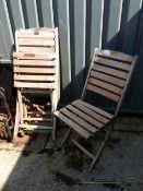 A SET OF FOUR PAGODA TEAK FOLDING PATIO CHAIRS.