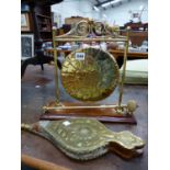 A BRASS TABLE GONG AND A SET OF BELLOWS.