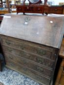 A GEORGE III OAK BUREAU WITH FOUR GRADED LONG DRAWERS