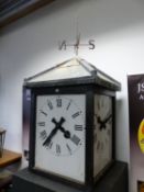 A BATTERY OPERATED THREE SIDED TURRET CLOCK WITH WEATHER VANED TOPPED ROOF