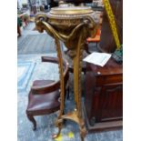 A GILT WOOD TRIPOD TORCHERE WITH RAMS HEADS FLANKING THE TOP
