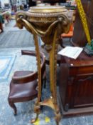 A GILT WOOD TRIPOD TORCHERE WITH RAMS HEADS FLANKING THE TOP