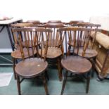 A SET OF EIGHT STICK BACK CHAIRS WITH ROUND OAK SEATS