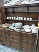 AN OAK DRESSER WITH ENCLOSED SHELF BACK ABOVE FOUR DRAWERS FLANKED BY CUPBOARDS. W 143 x D 48 x H