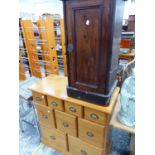 A MAHOGANY BEDSIDE CUPBOARD TOGETHER WITH A PINE CHEST OF NINE DRAWERS