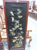 A JAPANESE BLACK SILK TWO FOLD SCREEN EMBROIDERED WITH BIRDS AND FLOWERS