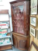 AN ASTRAGAL GLAZED MAHOGANY CORNER CUPBOARD TOGETHER WITH A ROUND FRONTED CORNER CUPBOARD